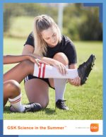 A woman examines a soccer player's leg. 