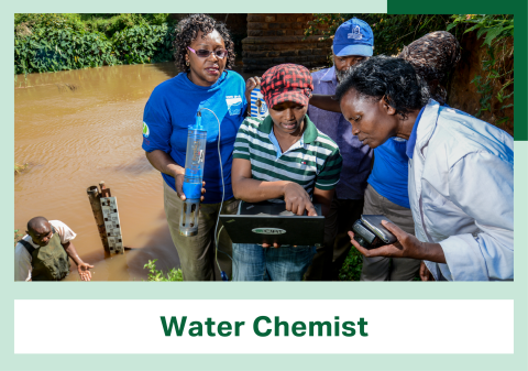 Five people stand at the edge of a river, gathered around a person holding a laptop computer. At the bottom of the image is a banner reading Water Chemist.
